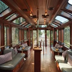 the inside of a train car with lots of windows and couches on it's sides