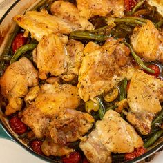 a pan filled with chicken and green beans