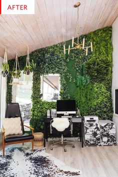 a living room with plants on the wall and a computer desk in front of it