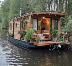 a house boat with plants on the deck