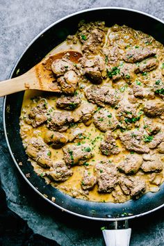 a skillet filled with meatballs and cheese