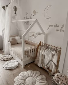 a baby's room with lots of white furniture and accessories on the wooden floor