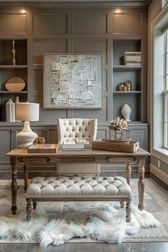 an elegant office with gray walls and white fur rugs on the floor in front of a large window