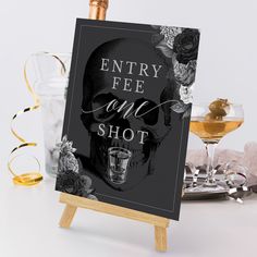 a sign that says, entry fee and shot on it next to glasses of wine