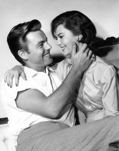 black and white photograph of a man hugging a woman