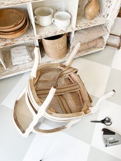 a white shelf filled with baskets and other items