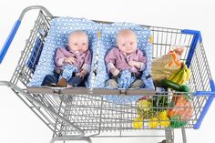 two baby babies sitting in a shopping cart with grocery bags on the back and one laying down