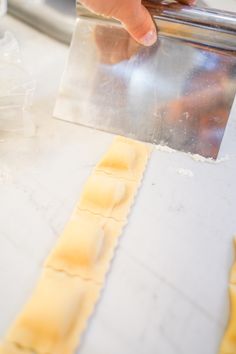 a person is making ravioli on a counter