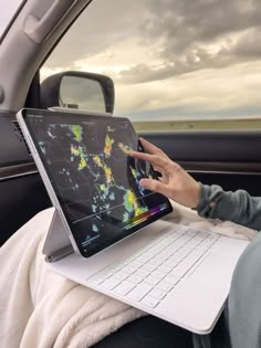 a person sitting in a car using a laptop computer