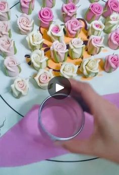 a person is holding a ring in front of some cupcakes