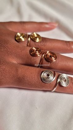 a woman's hand with three rings on it