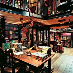 an old library with many books on the shelves and wooden tables in front of it