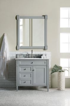 a bathroom with a sink, mirror and towel rack