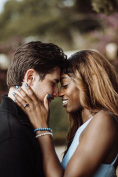 a young man and woman embracing each other