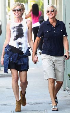 two people walking down the street holding hands