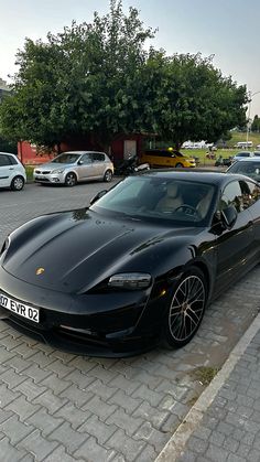 a black sports car is parked on the street