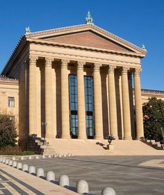 an old building with columns and pillars on the front