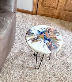 a coffee table sitting on top of a carpeted floor next to a gray couch