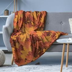 a couch with a blanket on it in a living room