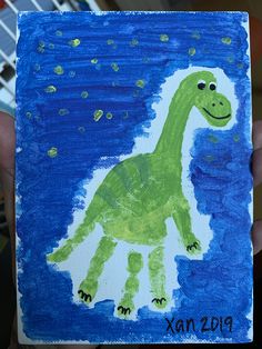 a child's drawing of a green dinosaur