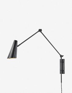 a black wall mounted lamp on a white background with the arm extended to one light