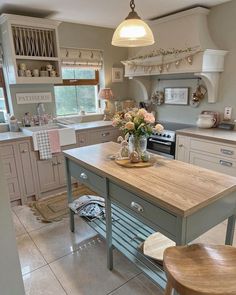 a kitchen with an island, stove and sink in it's centerpieces