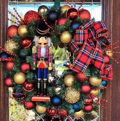 a nutcracker wreath with christmas decorations on the front door