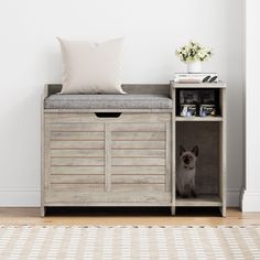 a dog is sitting in a wooden crate with a cushion on it's back