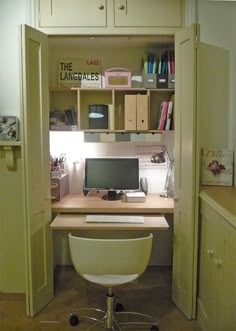 an office area with a desk, computer and bookshelf in the doorway to another room