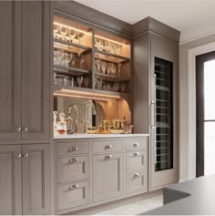 a kitchen filled with lots of cabinets and wine glasses