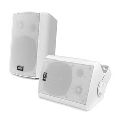 two white speakers sitting next to each other