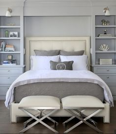 a bedroom with white furniture and gray walls