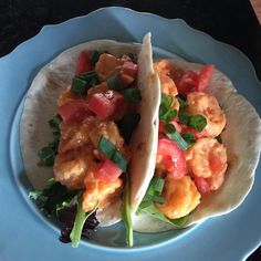 two fish tacos on a blue plate