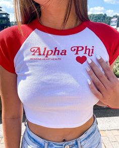 a woman wearing a red and white shirt with the words aloha phi on it