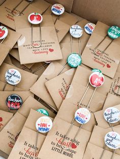 many different types of buttons are on brown envelopes that say love is in the air