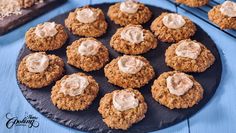 several cookies with icing on a black plate