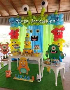 an image of a birthday party with balloons and decorations on the table in the shape of monsters