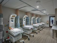 a row of beds in a hospital room