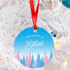 a personalized christmas ornament hanging from a tree