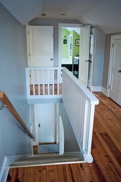 an empty room with stairs leading up to the second floor and another door on the other side