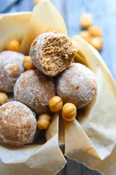 a bunch of doughnuts sitting on top of each other in a paper bag