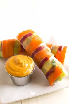 some food is sitting on a white plate and ready to be eaten with dipping sauce