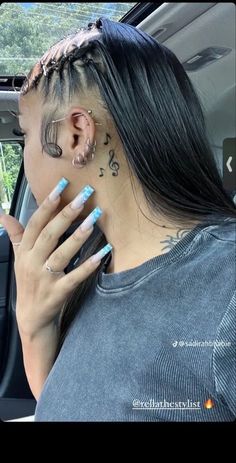 a woman with tattoos on her neck sitting in a car