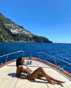 a woman laying on the back of a boat