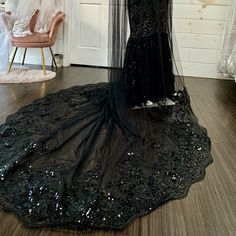 a black wedding dress on display in a room