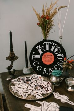 a table topped with plates and vases filled with different types of paper cutouts