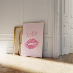 a pink poster with the word xoxo on it next to an empty frame