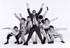 a group of young men standing next to each other in front of a white background