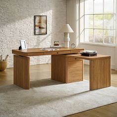 a wooden desk sitting on top of a white rug in a living room next to a window