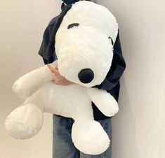 a person holding a large white teddy bear